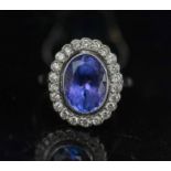 A FINE TANZANITE AND DIAMOND CLUSTER RING, finely mounted in eighteen carat white gold,