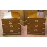 CAMPAIGN STYLE BEDSIDE CHESTS, a pair, teak and brass bound each with three drawers,