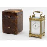 AN ANTIQUE MINIATURE FRENCH CARRIAGE CLOCK, the gilt bronze case with reeded columns,