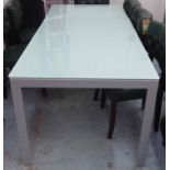 DINING TABLE, extending greenish glass top on square metal supports, 140cm to 200cm x 90cm x 74cm H.