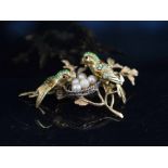 NICOLETTI MILAN 1960's, a small gem set eighteen carat gold and enamel nesting parakeet brooch.