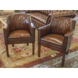 BRIDGE ARMCHAIRS, a pair, 1930 tan brown leather upholstered with double piping and square supports.
