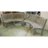 COUNTRY HOUSE GARDEN BENCHES, a pair, weathered teak slatted of concave form by Westminster,