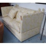 KNOLE SOFA, two seater in a gold floral fabric on block supports, 191cm L.