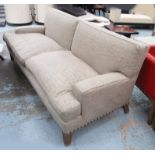 PETER DUDGEON SOFA, large two seater in studded, beige Andrew Martin fabric, on square supports,