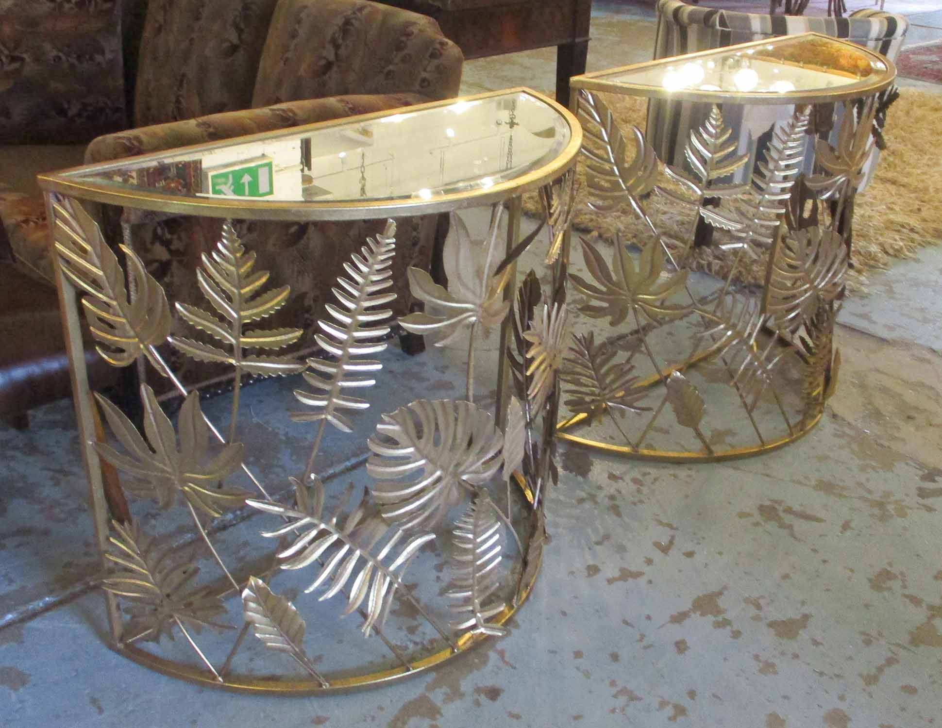 DEMI LUNE CONSOLE TABLES, a pair, gilt metal framed,