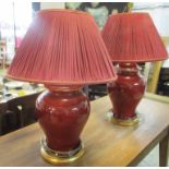 TABLE LAMPS, a pair, Sang de Boeuf with red shades, 74cm H.