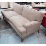 PETER DUDGEON SOFA, large two seater in studded, beige Andrew Martin fabric, on square supports,