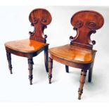 HALL CHAIRS, a pair, Regency mahogany with scroll backs bow panel seat and turned front supports.