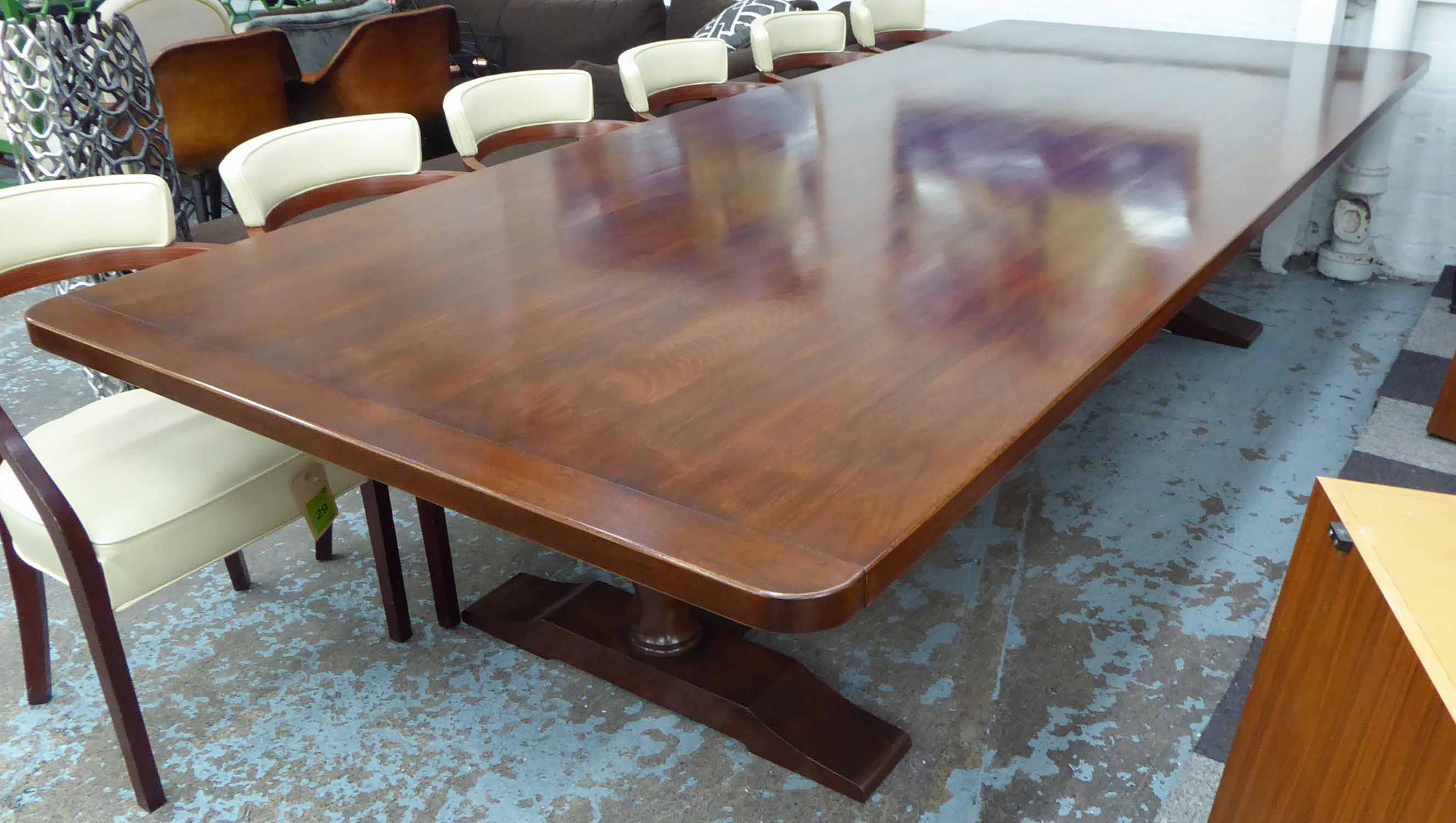 DINING TABLE, walnut of large proportions on baluster turned trestle supports joined by a stretcher,
