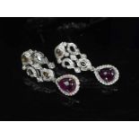 A PAIR OF RUBY AND DIAMOND PENDANT EARRINGS, mounted in 18 carat white gold, approx 4cm Long,