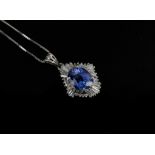 A SAPPHIRE AND DIAMOND PENDANT, set to the centre with an oval mixed cut sapphire weighing approx 2.