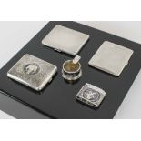 A GROUP OF FIVE VINTAGE SILVER ITEMS, comprising three cigarette cases, a light and an ashtray.