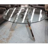 ANDREW MARTIN DINING TABLE, circular with glass top on three chromed metal supports,