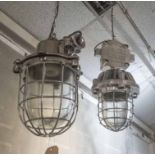 INDUSTRIAL LIGHTS, two polished metal with caged shades, one 40cm H, the other 48cm H.