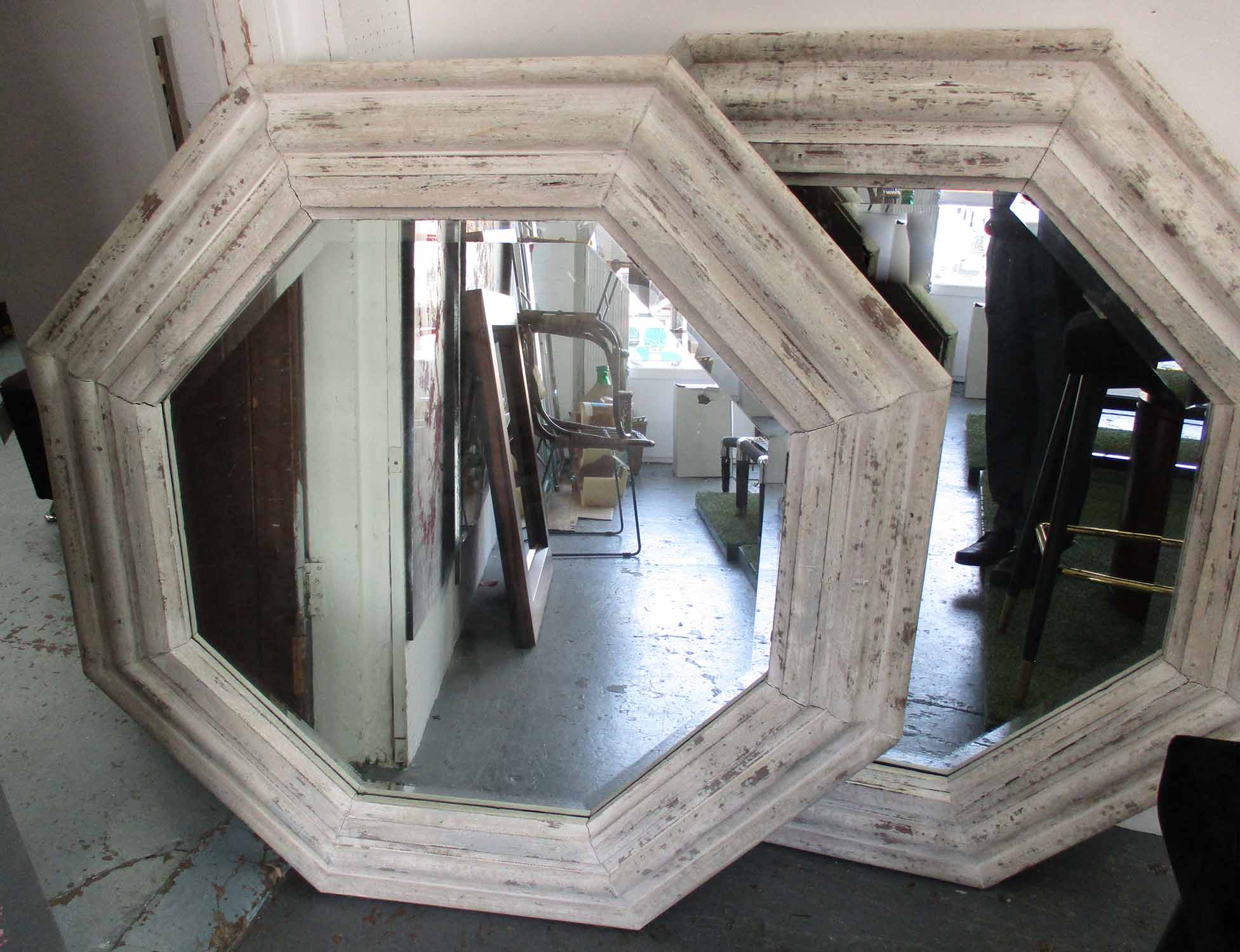 MIRRORS, a pair, hexagonal bevelled plate in a distressed white painted frame, 123cm x 123cm.