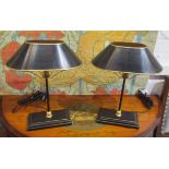 TABLE LAMPS, a pair, Toleware style black with a gold border on a rectangular wooden platform base,
