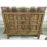 TIBETAN CABINET, black lacquered with polychrome traditional decorations containing two doors,