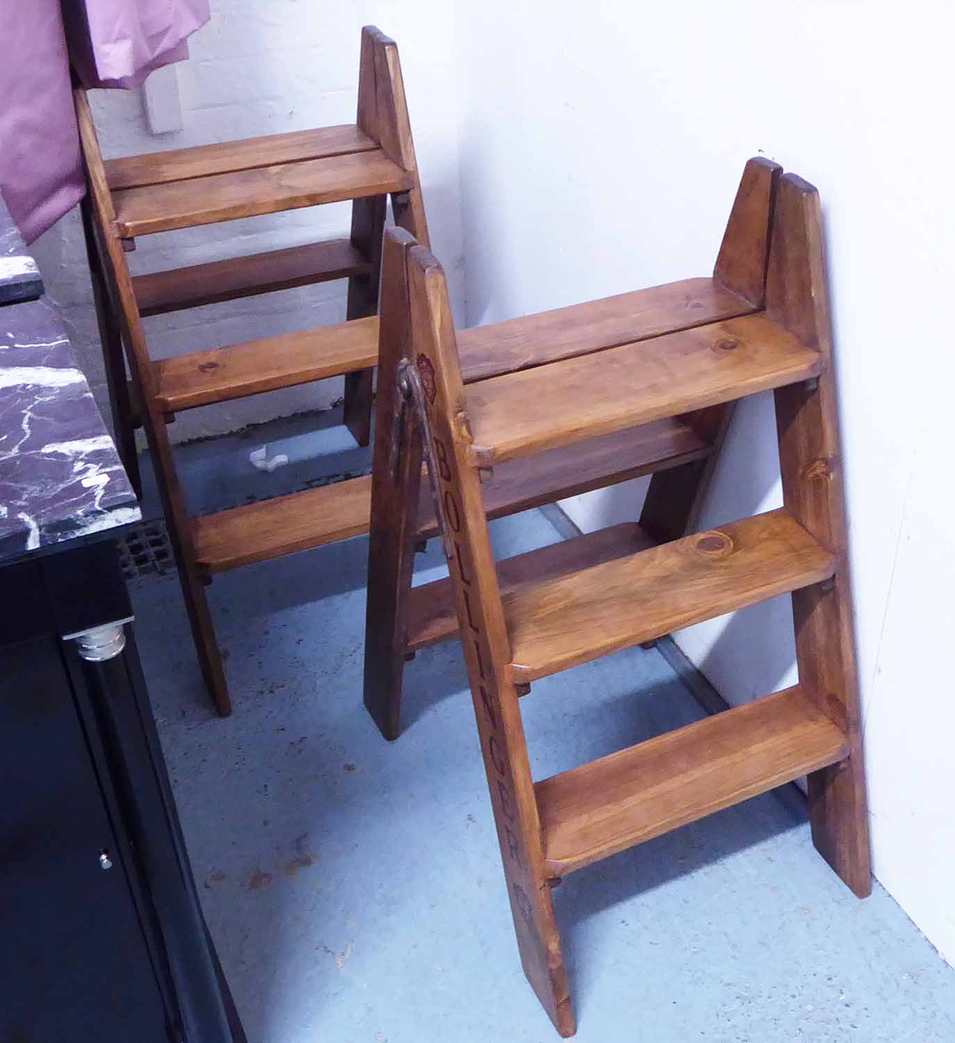 CELLAR STEP LADDERS, a pair, stamped with various Champagne houses, 84cm H.