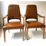 ELBOW CHAIRS, a pair, 1970's Scandinavian walnut framed with studded mid brown leather upholstery,