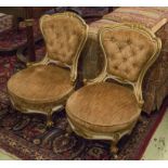 NURSING CHAIRS, a pair, Victorian white and gilt painted in buttoned striped brown velvet, 49cm W.