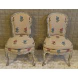 SALON CHAIRS, a pair, 19th century French painted in floral patterned material with cushion seats.