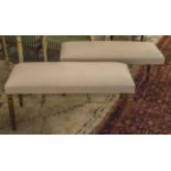 STOOLS, a pair, each with beige upholstery on reeded turned supports, 98cm L x 46cm H x 40cm D.