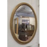 OVAL MIRROR, with a gilt rope twist design frame, 91cm x 66cm.