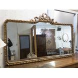 WALL MIRROR, the gilt frame with ribbon detail, tied ribbon mount and shaped plate,
