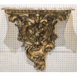 WALL BRACKET, Victorian giltwood with serpentine marble top and foliate carving,