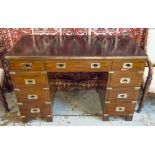 CAMPAIGN STYLE DESK, mahogany and brass bound with leather top above nine drawers,