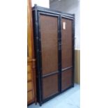 WARDROBE, Chinese having caned doors in a faux bamboo surround in an ebonised finish,