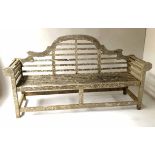 LUTYENS STYLE BENCH, silvery weathered teak of slatted form after a design by Sir Edwin Lutyens,