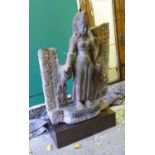 LAKSMI STATUE, Indian carved stone on a metal plinth, 75cm H x 51cm W.