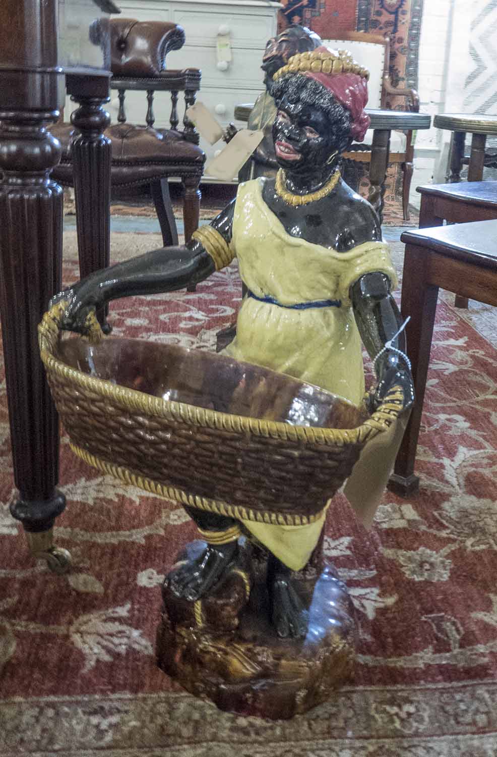 A LATE 19TH CENTURY CONTINENTAL POTTERY FIGURE OF A FEMALE BLACKAMOOR,