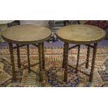 INDIAN TABLES, a near pair, early 20th century beech with decorated circular brass tops,