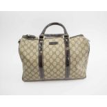 GUCCI BOSTON BAG, with iconic GG print coated canvas with patent leather top handles and trims,