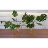 FAUX MONSTERA DELICIOSA PLANTS, a pair, on contemporary stands, 100cm H.