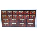 APOTHECARY DRAWERS, a set of twenty, Victorian mahogany fronted retaining gilt glass labels,