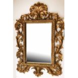 WALL MIRROR, French Rococo style carved giltwood with bevelled plate and C scroll carved frame,