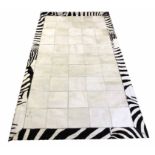 COWHIDE RUG, 215cm x 119cm, zebra design border.