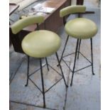 BARSTOOLS, a pair in olive green on black metal supports by Rose Uniacke, 37cm W.