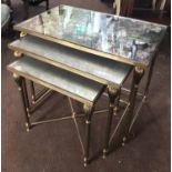 NEST OF TABLES, french 1930's mottled mirror tops on reeded brass supports, largest 54.