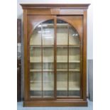 GRANGE BOOKCASE, 'Stendhal' with two sliding glazed arched doors enclosing shelves on a plinth base,
