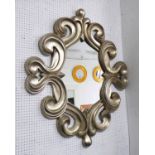 SCROLL WALL MIRROR, silvered scroll framed mirror with shaped oval plate, 120cm H.