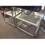 SIDE TABLES, a pair, square glass top with silvered borders on silvered reeded supports, 50.