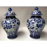VASES, a pair, Chinese ceramic blue and white vases with blossom and lids.