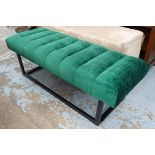 BENCH/FOOTSTOOL, in green and black patterned upholstery on ebonised open supports,