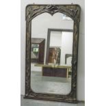 WALL MIRROR, Art Nouveau bronze with arched bull rush cast frame, 134cm H x 75cm.
