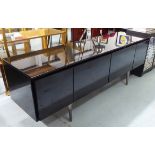 MEDIA UNIT, in black lacquer with four cupboards on metal supports, 161cm x 43cm x 57cm H.